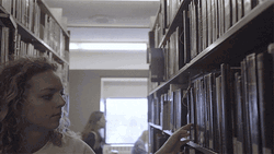 Woman Reading Book Inside Library