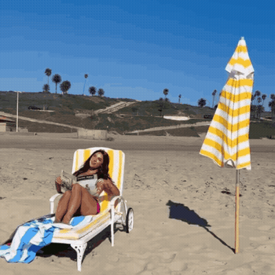 Woman Reading Newspaper On Beach Chair GIF