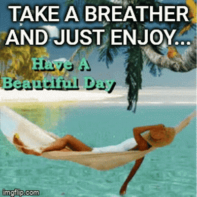Woman Relaxing In Hammock Over Ocean GIF