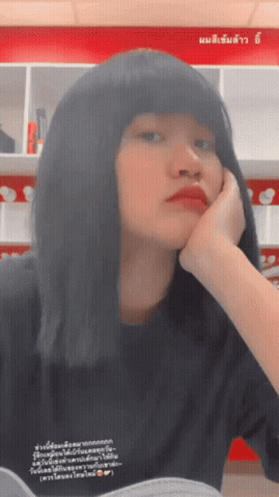 Woman Resting Head On Hand In Front Of Sign Saying A GIF