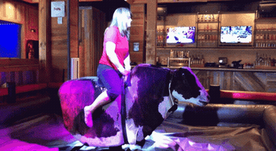 Woman Riding Bull In Bar GIF