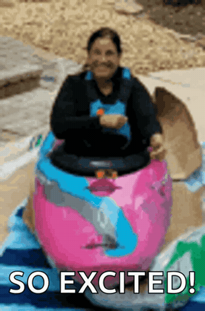 Woman Riding Pink And Blue Toy Car Saying So Excited GIF
