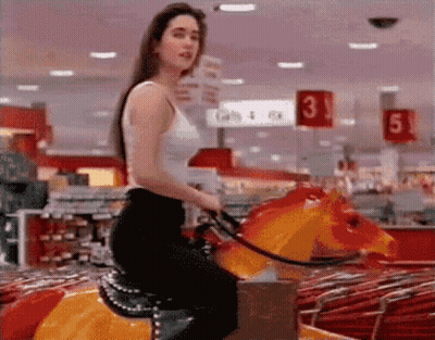Woman Riding Rocking Horse In Store With Number 3 GIF