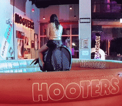 Woman Riding Rodeo Bull At Hooters Sign GIF