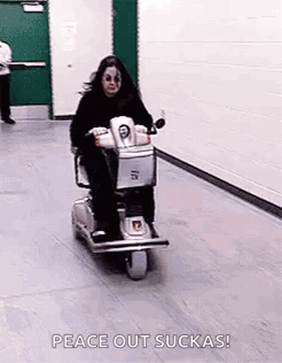 Woman Riding Scooter In Hallway GIF