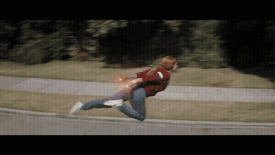 Woman Running Down Sidewalk With Red Light From Hand GIF