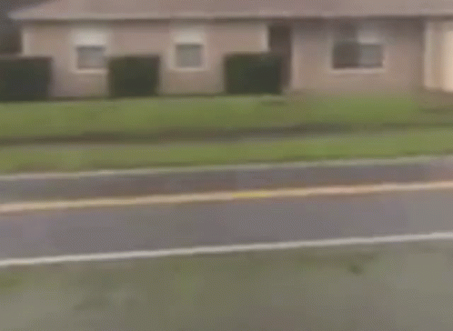 Woman Running Down Street With American Flag GIF