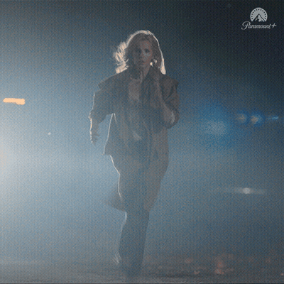 Woman Running In Dark Room With Paramount Logo GIF