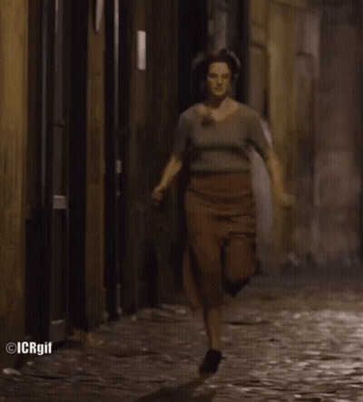 Woman Running On Cobblestone Street GIF