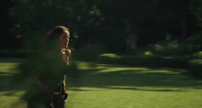Woman Running Through Field Of Greenery GIF