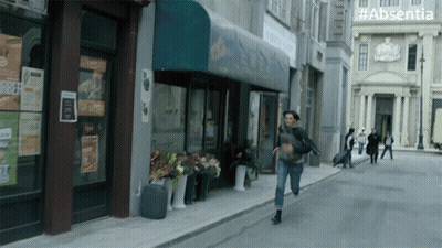 Woman Running With #Absentia Sign GIF