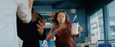 Woman Running With Milk Cup Carried By Man GIF
