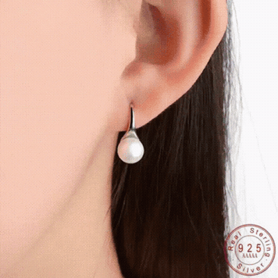 Woman's Ear With Sterling Silver Pearl Earrings GIF