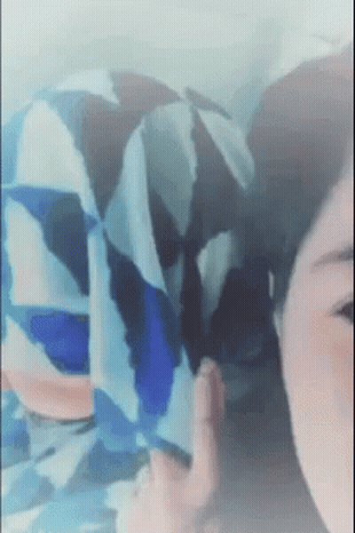 Woman's Face Close Up With Blue And White Shirt Pattern GIF