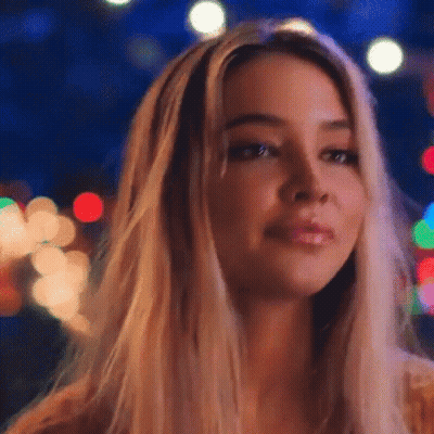 Woman's Face Close Up With Christmas Lights GIF