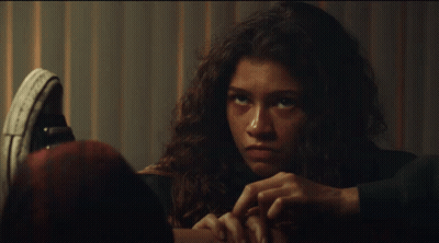 Woman's Face Close-Up With Converse Shoe GIF