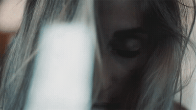 Woman's Face Close Up With Light Behind GIF