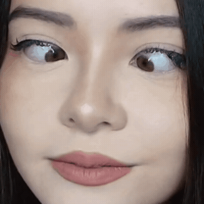 Woman's Face Close Up With Slight Smile GIF