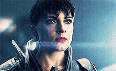 Woman's Face Close Up With Sword Behind Ear GIF