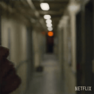 Woman's Face In Hallway With Red Light GIF