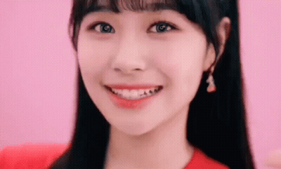 Woman's Face On Pink Background In Red Shirt GIF