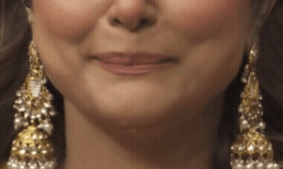 Woman's Face Wearing Gold And Pearl Earrings GIF