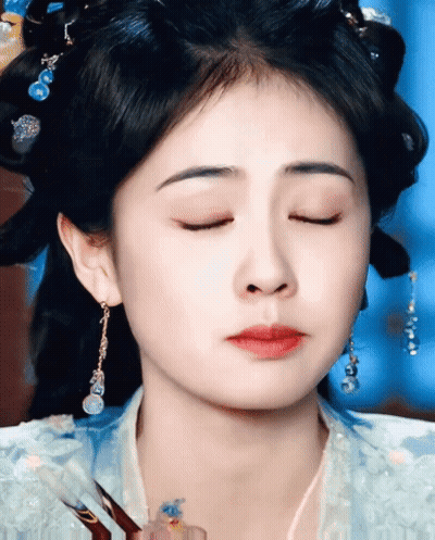 Woman's Face With Earrings And Eyes Closed GIF