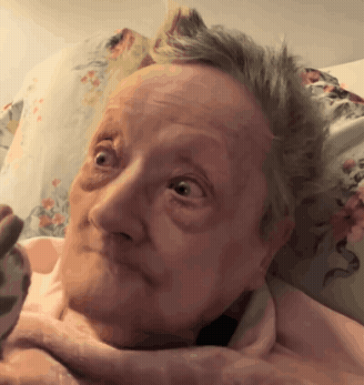 Woman's Face With Pink Blanket GIF