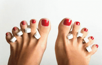 Woman's Feet With Red Toenails GIF