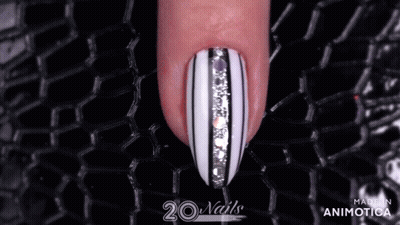 Woman's Finger With Black And White Striped Nails GIF