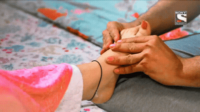 Woman's Foot Massaged By Man In Front Of Sony Advertisement GIF