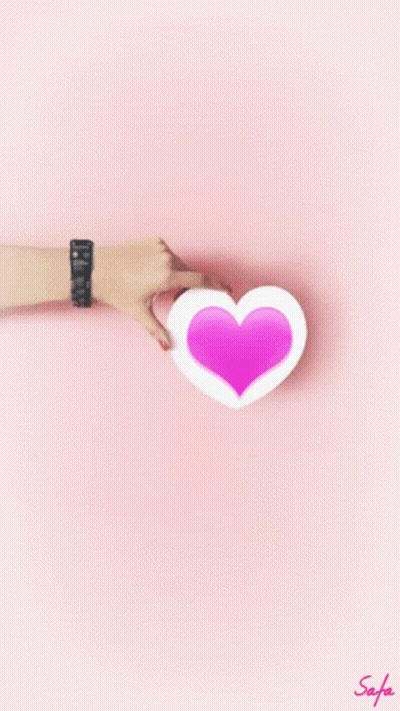 Woman's Hand Holding Pink Heart