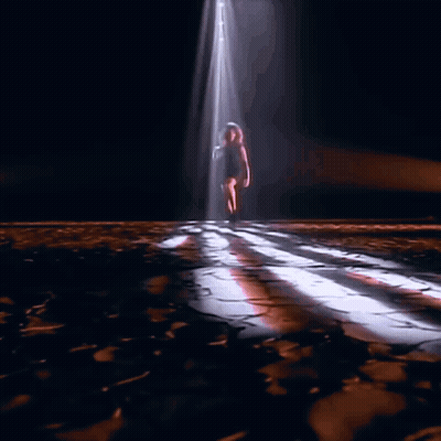 Woman's Legs In Black Boots On Wooden Floor GIF