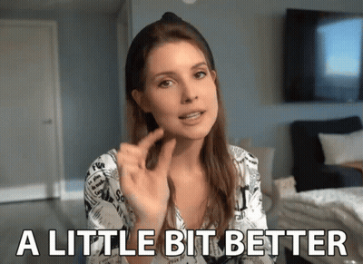 Woman Saying A Little Bit Better With Peace Sign GIF