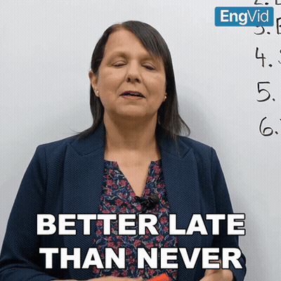 Woman Saying Better Late Than Never In Front Of Numbered Board GIF