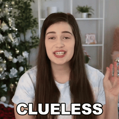 Woman Saying Clueless Holding Key Christmas Tree GIF
