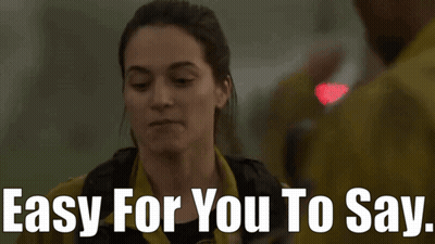 Woman Saying Easy For You To Say To Man In Yellow Jacket GIF