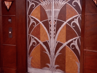 Woman Saying Enjoy The Day In Front Of Door GIF