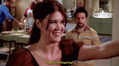 Woman Saying Happy Thanksgiving To Striped Shirt Man GIF