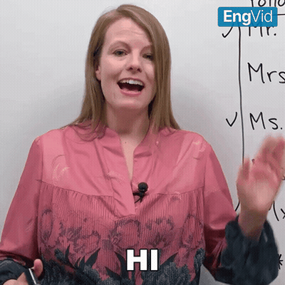 Woman Saying Hi in Front of Whiteboard With Mrs