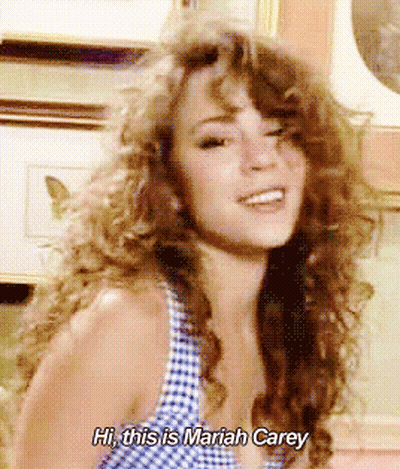 Woman Saying Hi This Is Mariah Carey In Front Of Picture GIF