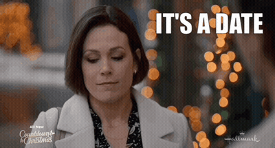 Woman Saying It's A Date In Front Of Christmas Lights GIF