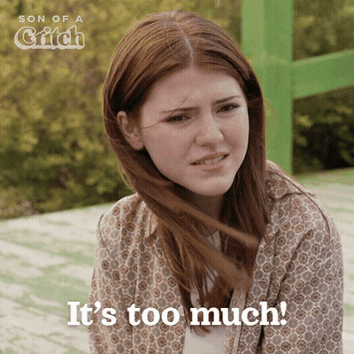 Woman Saying It's Too Much In Front Of Green Sign GIF
