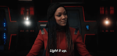 Woman Saying Light It Up In Dark Room GIF