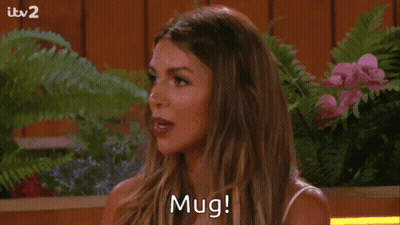 Woman Saying Mug Among Flowers GIF