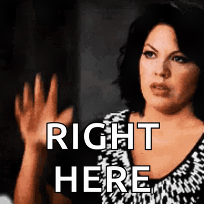 Woman Saying Right Here With Hands Up GIF
