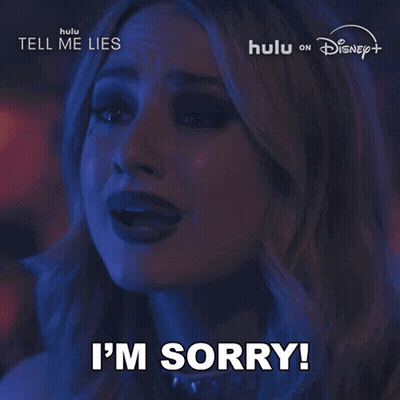 Woman Saying Sorry In Front Of Hulu Disney Plus Sign GIF
