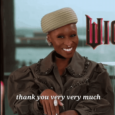 Woman Saying Thank You Very Much In Front Of Sign GIF