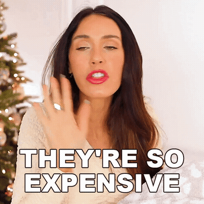 Woman Saying They're So Expensive By Christmas Tree GIF