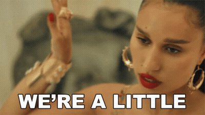 Woman Saying We're A Little While Wearing Hoop Earrings GIF